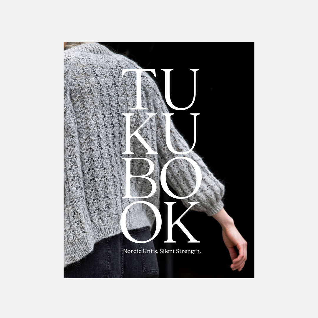 Book cover with text 'TUKU BOOK' and a person wearing a knitted sweater.