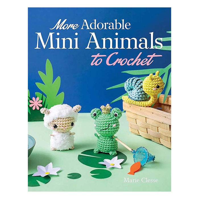 Book cover of 'More Adorable Mini Animals to Crochet' with crocheted animals and a basket on a green background.