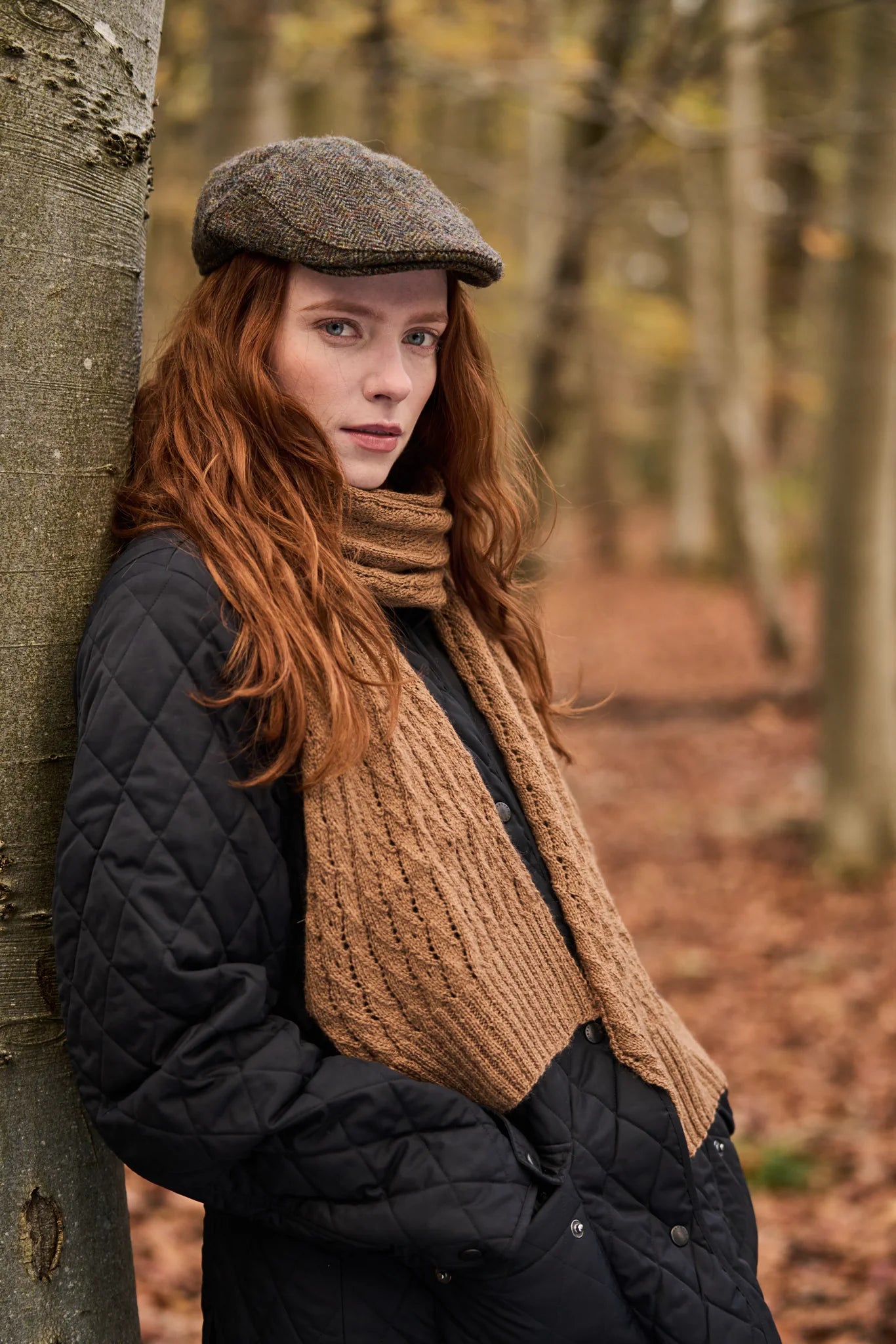 The Bramble & Fleece Stone Scarf, a cabled scarf knitted in Wooltrace 4 Ply