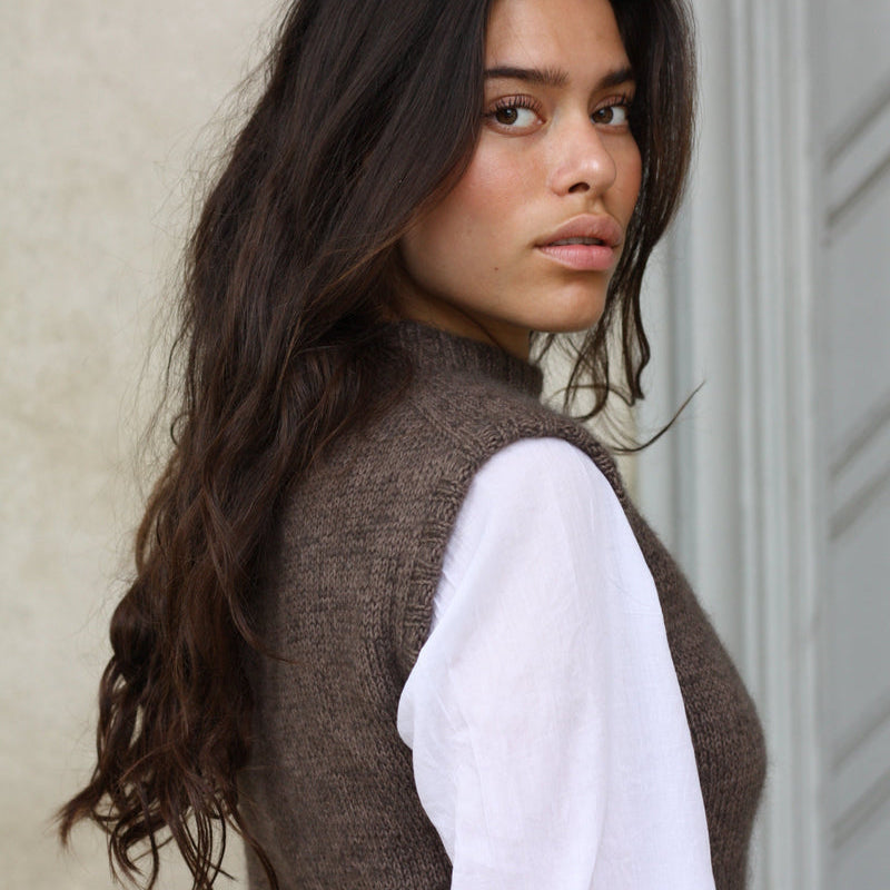 Side view of the Knitting for Olive Olive's Vest slipover worn over a white shirt