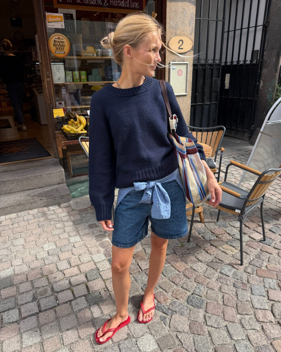 Woman wearing the blue PetiteKnit Vega Sweater